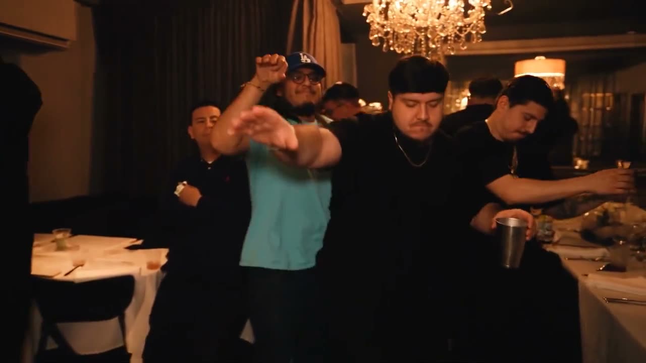 A guy in a black tee runs the chandelier room.