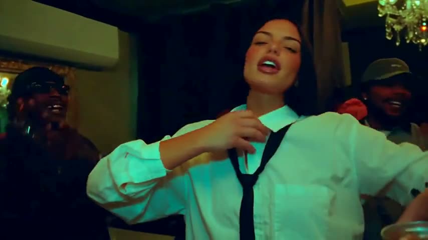 A woman in a mint shirt and tie takes the lead.