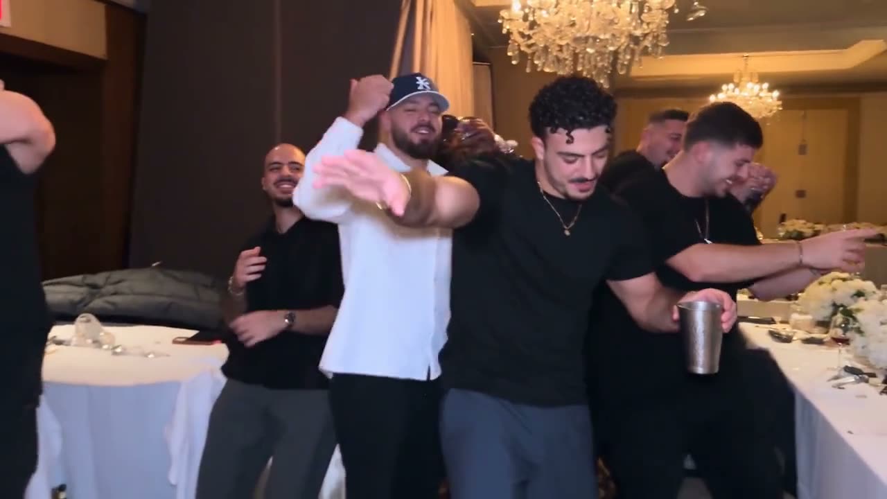 Black tee and a gold chain, the whole crowd behind him.
